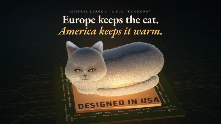 A chunky grey cat lies on a warm, glowing computer chip marked 'Designed in USA' and looks up, unimpressed