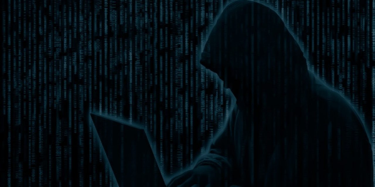 Conceptual image of a hacker on matrix background of falling green computer code digits